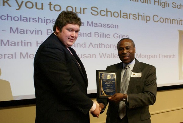 In April, Landon Wilcox (l) receives a Lift Off Scholarship from Freddie Blakely, chapter chairman.